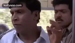 Two men on a bus reacting with shock