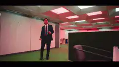 Man in suit dancing in office