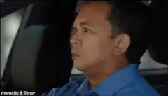 Man in car gives thumbs up