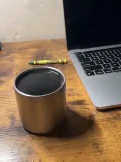 coffee cup and crayon on desk