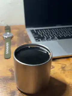 coffee cup on desk with laptop