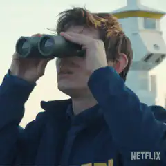 Man lowers binoculars in shock