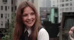 Diane Keaton smiling and drinking wine