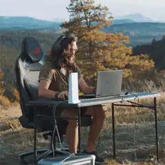 Man gaming outdoors in nature