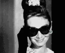 Audrey Hepburn removes sunglasses