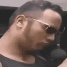 Man in sunglasses giving a thumbs up