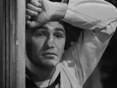 Man leaning on doorframe looking worried