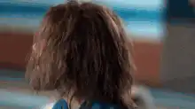 Caveman turns head and smiles