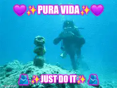 Scuba diver blows bubble ring at rock stack