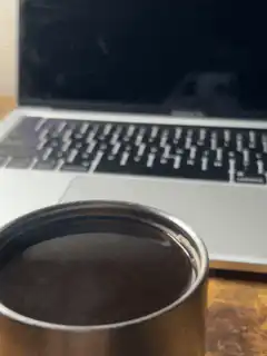 coffee cup in front of laptop