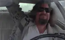 The Dude driving and smiling
