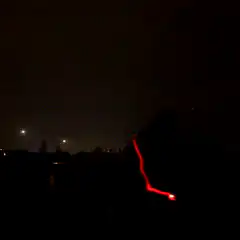 person with glowing lights in dark