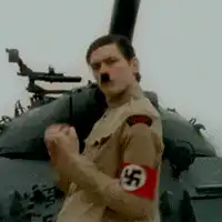 Hitler flexing in front of tank