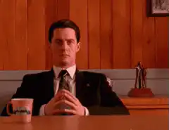 Agent Cooper sitting at a table