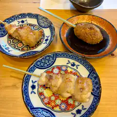 three plates of grilled chicken skewers
