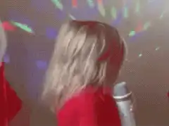 Justin Bieber singing with long blonde hair