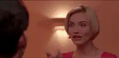 Cameron Diaz smiles and touches her hair