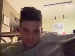 Man in grey hoodie looking at camera