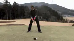 Man hits golf ball and falls over