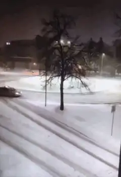 Car drifting on snowy road at night