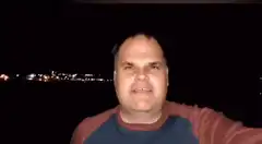 Man screaming on a boat at night