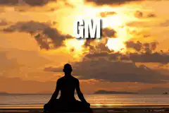 Meditating silhouette with GM text at sunset