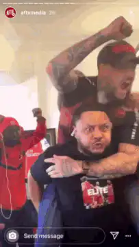Men celebrating excitedly in office