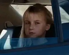 Blonde girl flips the bird in car