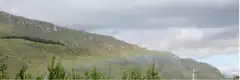 rainbow over green mountain