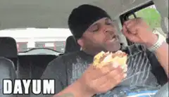 Man eating sandwich in car says dayum