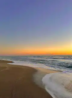 sunset waves on sandy beach
