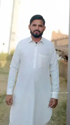 Man in white kurta standing outdoors