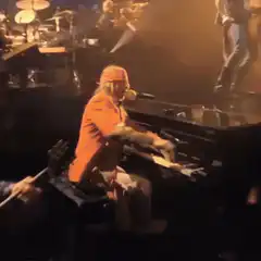 Billy Joel playing piano and singing