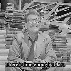 Man laughing with books behind him