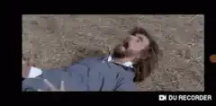 Man lying in hay screaming