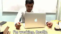 Man reveals pizza under laptop