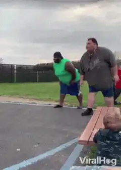 Man in grey shirt trips and falls while running