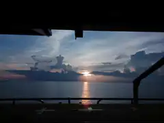 Sunset over the ocean from a balcony