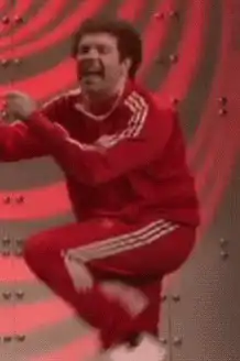 Danny Trejo in red tracksuit screaming