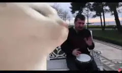 Cat headbanging to man playing drum