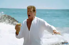 David Hasselhoff on the beach with a drink