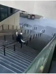 person sliding down handrail