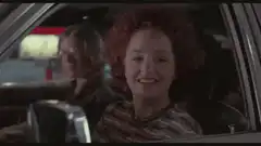 Car full of people singing and waving