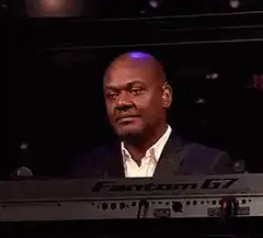 Man smiling behind keyboard