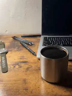 coffee cup on desk with laptop