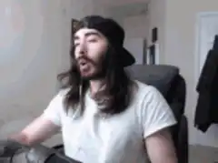 man in white shirt throws hands up