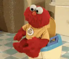 Elmo sitting on a potty
