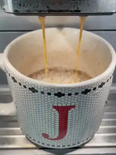 Espresso pouring into a mug