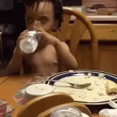 Toddler drinking water and rolling eyes