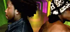 Two men turn to look at the camera